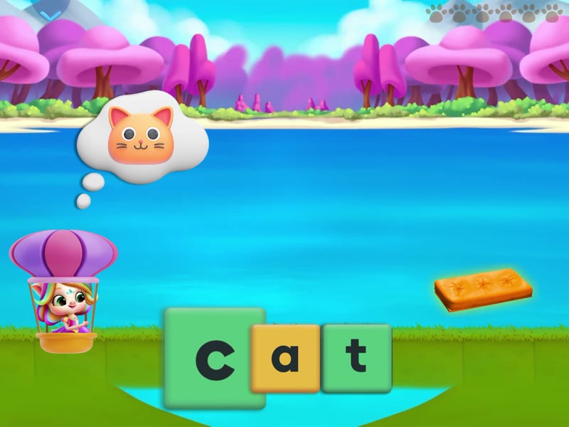 Spelling game: a child builds the word cat from letter tiles